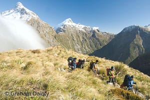 Trampers cross the MacKinnon Pass, Milford Track, Fiordland. © Graham Dainty
